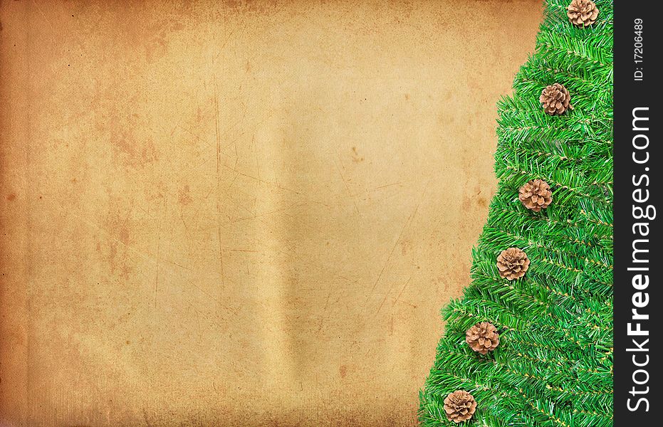 Christmas Tree Branches Bordering a ancient paper textures Background