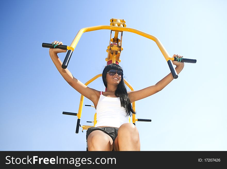 Perfect young mode working out on fitness playground. Perfect young mode working out on fitness playground