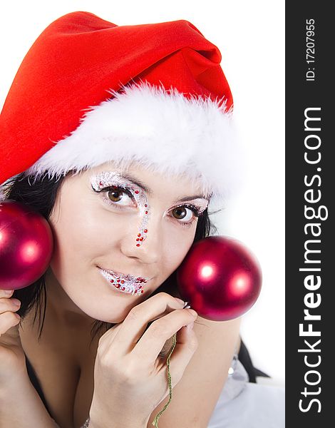 Carnival girl in christmass hat holds a red spheres. Carnival girl in christmass hat holds a red spheres