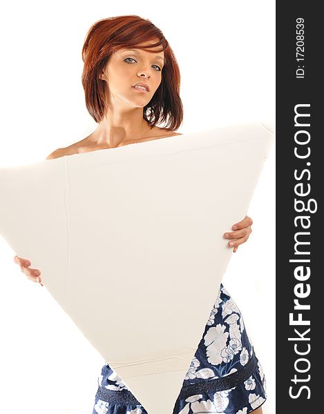 Sexy redhead standing holding a blank sign on an isolated white background looking at the camera seductively. Sexy redhead standing holding a blank sign on an isolated white background looking at the camera seductively