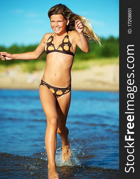 Happy girl running in the sea