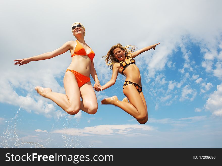 Happy friends jumping an outdoors