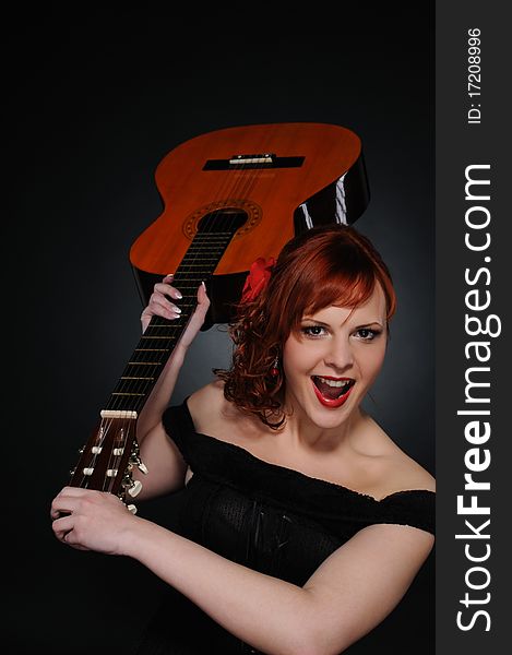 Happy redhead woman with guitar