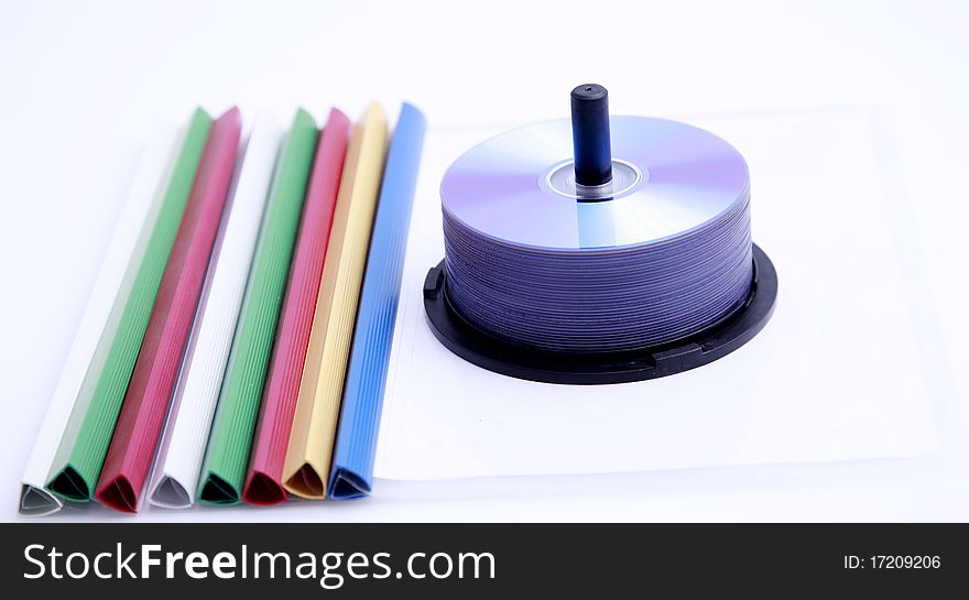 Colorful paper clips and a stack of CD-ROM. Colorful paper clips and a stack of CD-ROM