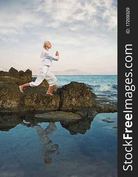 Beautiful young woman doing yoga exercise