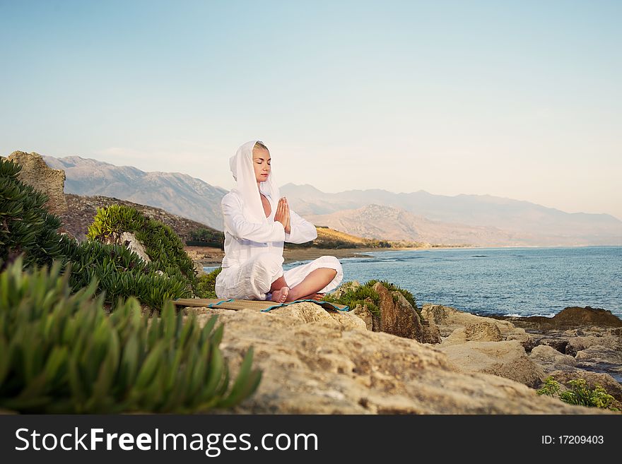 Beautiful woman doing yoga exercise outdoors