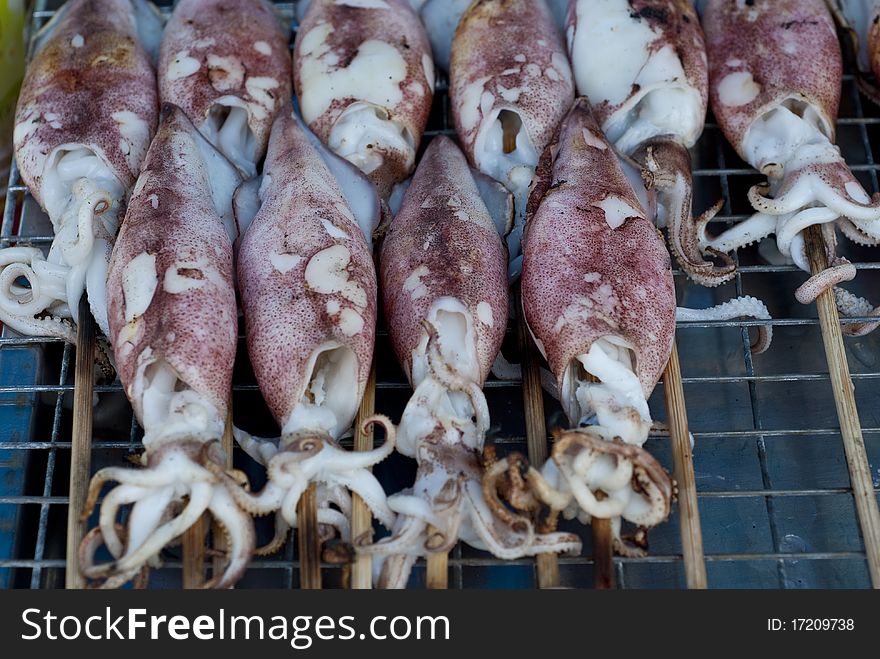 Grilled squids sold in a Thai market