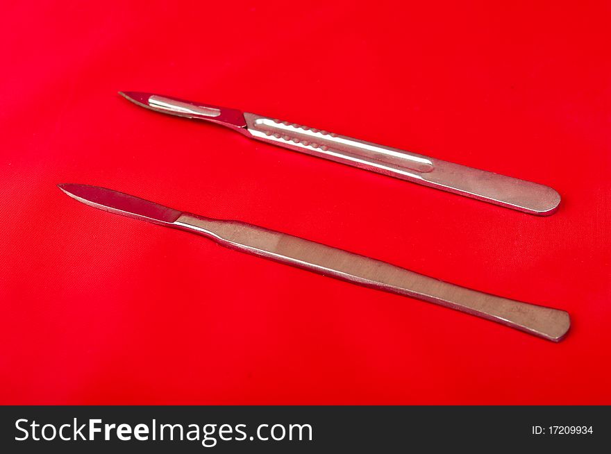 Scalpel on a red background