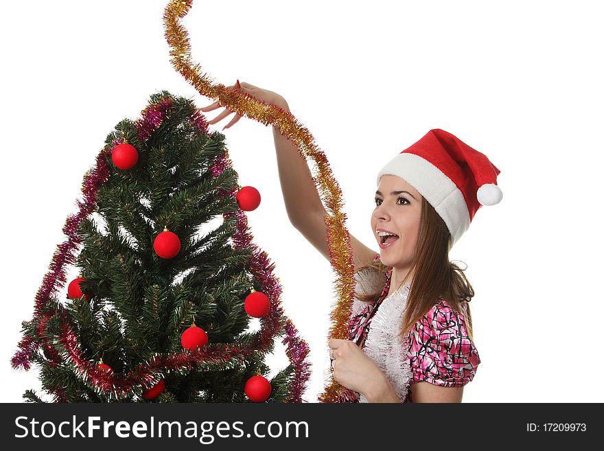 Woman in a christmas hat decorate a christmas tree. Woman in a christmas hat decorate a christmas tree