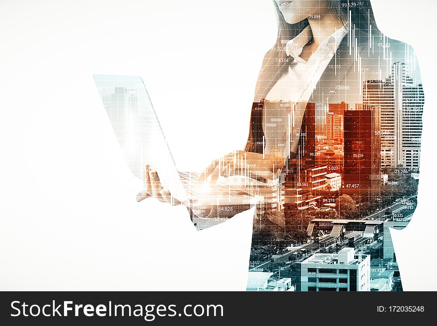 Double exposure of businesswoman silhouette using laptop