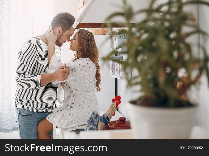 Beautiful couple spend time in a kitchen