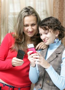 Two Girls With Mobile Phones Royalty Free Stock Photography Two Girls With Mobile Phones Royalty Free Stock Photography
