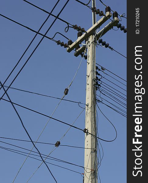 Power lines and illuminated street light, low angle view