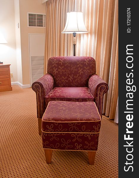 Elegant Red Armchair And Pouffe On Carpet