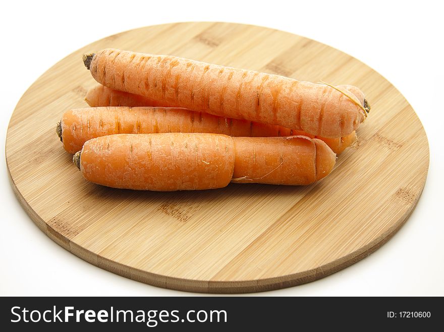 Carrots on round wood plate