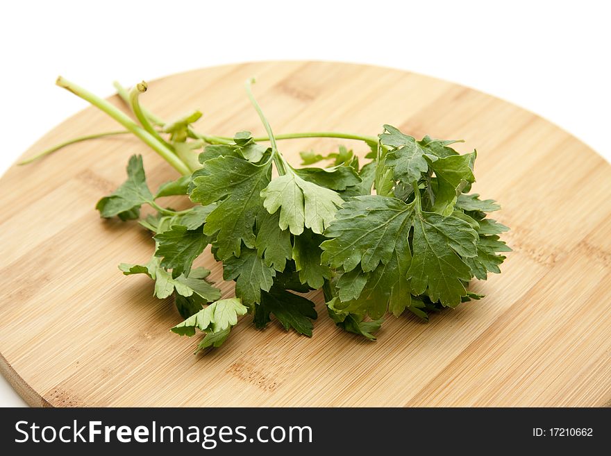 Parsley on round wood plate