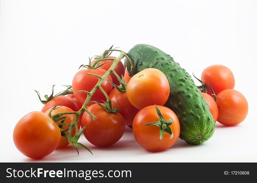 Tomatoes and cucumbers on a white background. Healthy food for people.