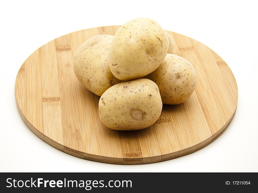 Potatoes on round wood plate