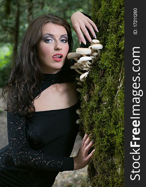 Beauty woman in forest with mushrooms