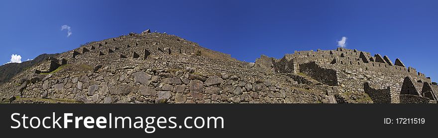 Low wide panorama view of part of Machu Picchu ruins and terraces. Low wide panorama view of part of Machu Picchu ruins and terraces