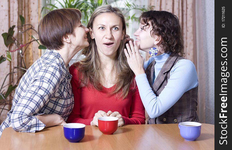 Two women share secrets with a friend