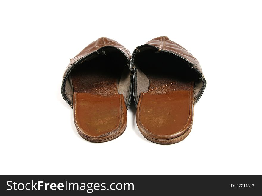 Old leather slippers on white background