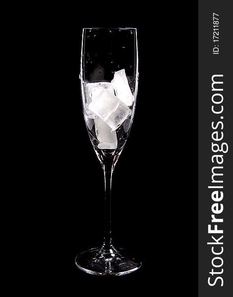 Glass with ice cubes  isolated on black background