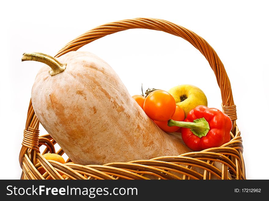 Pumpkin and harvest in a basket on a white background. Pumpkin and harvest in a basket on a white background