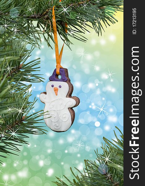 Christmas theme. Beautiful postcard. Christmas Gingerbread snowman on the fir-tree. Christmas theme. Beautiful postcard. Christmas Gingerbread snowman on the fir-tree