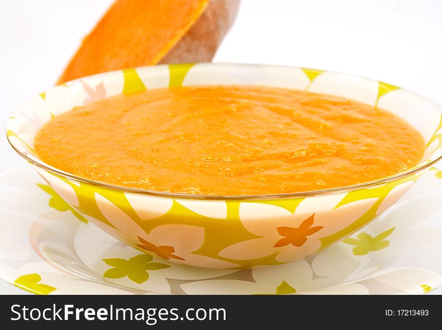 Pumpkin soup in a bowl on a white background