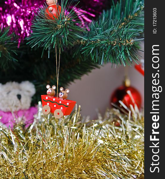 Wooden christmas trinket hanging from a fir tree. Wooden christmas trinket hanging from a fir tree.