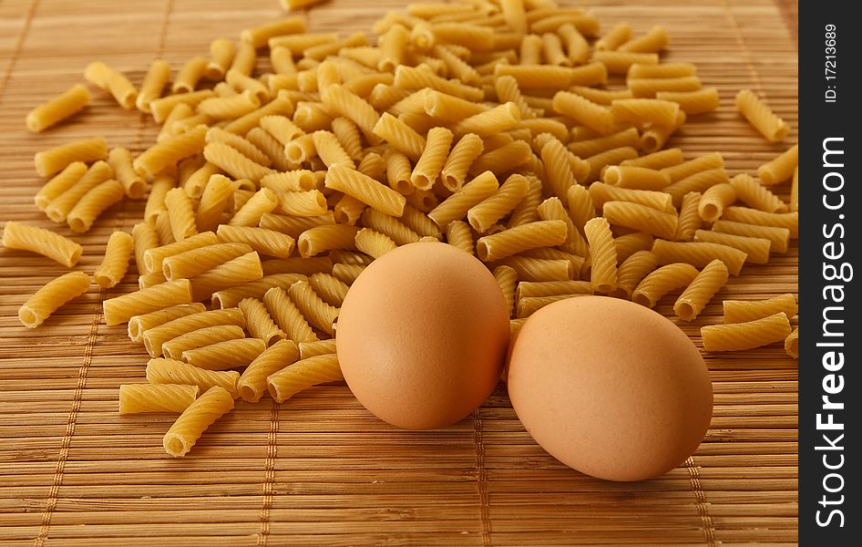 Scattered macaroni and two eggs. Scattered macaroni and two eggs