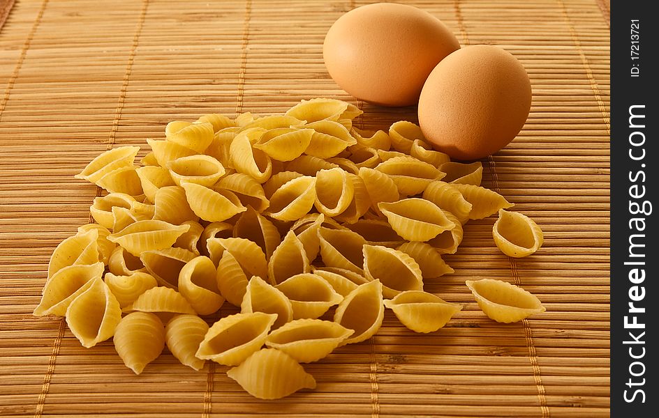 Scattered pasta and two eggs. Scattered pasta and two eggs