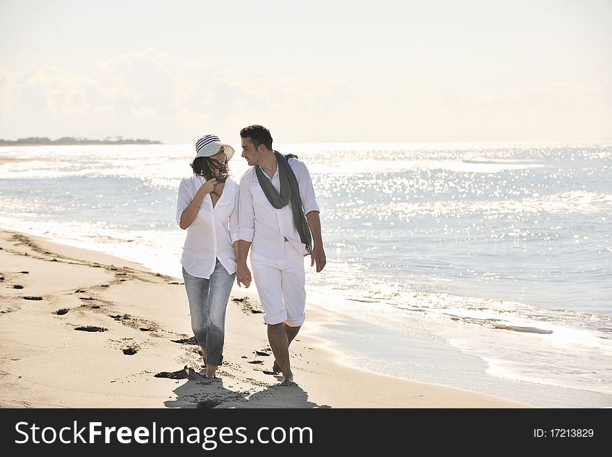 Happy young couple in white clothing  have romantic recreation and   fun at beautiful beach on  vacations. Happy young couple in white clothing  have romantic recreation and   fun at beautiful beach on  vacations