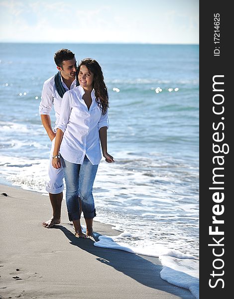 Happy Young Couple Have Fun At Beautiful Beach