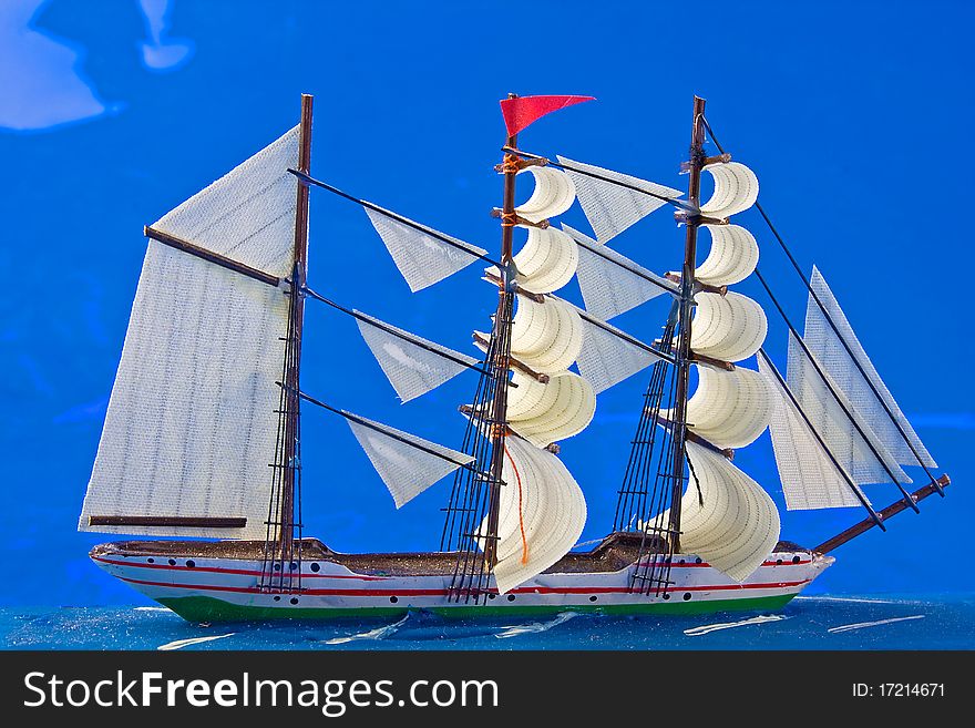 Sailing boat on blue background