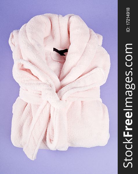 Soft pink lady's bathrobe on purple background. Soft pink lady's bathrobe on purple background.