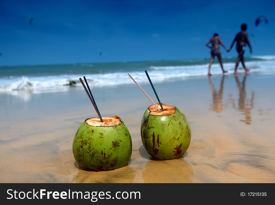 Coconut cocktail on beach sand