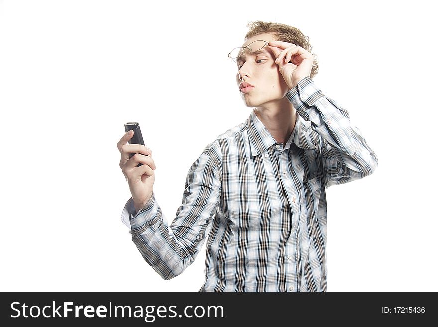 Studio portrait of young man with phone over white. Studio portrait of young man with phone over white