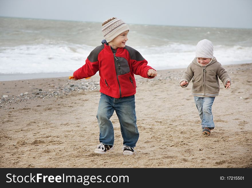 Two children running on beach