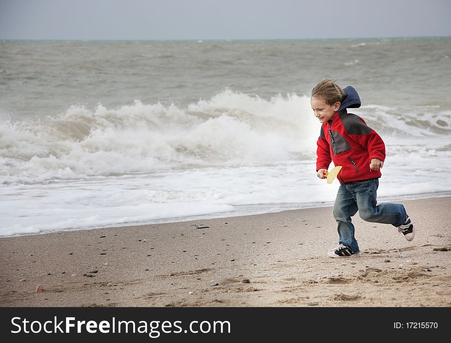 Happy young boy running on beach. Happy young boy running on beach
