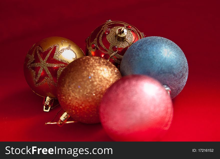 Varicoloured christmas balls on red  background  . Varicoloured christmas balls on red  background  .