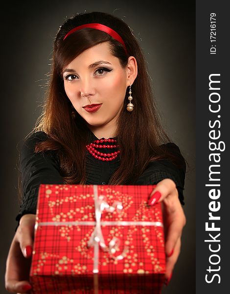 Beautiful retro woman with red present. Beautiful retro woman with red present