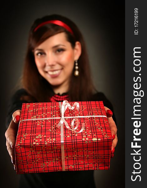 Beautiful retro woman with red present. Beautiful retro woman with red present