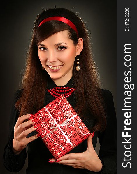 Beautiful retro woman with red present. Beautiful retro woman with red present