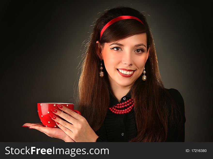 Beautiful retro woman with red cup