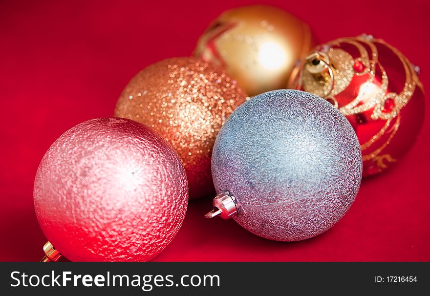 Varicoloured christmas balls on red  background  . Varicoloured christmas balls on red  background  .