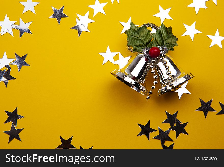 Christmas Bells With Holly Berry And Stars On The Yellow Background. Christmas Bells With Holly Berry And Stars On The Yellow Background