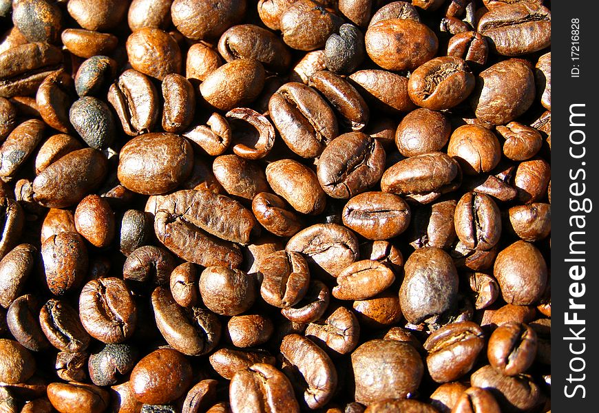 Detail phototexture of the roasted coffee beans background. Detail phototexture of the roasted coffee beans background