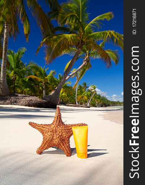 Starfish and sun protection tube on caribbean beach, Dominican Republic